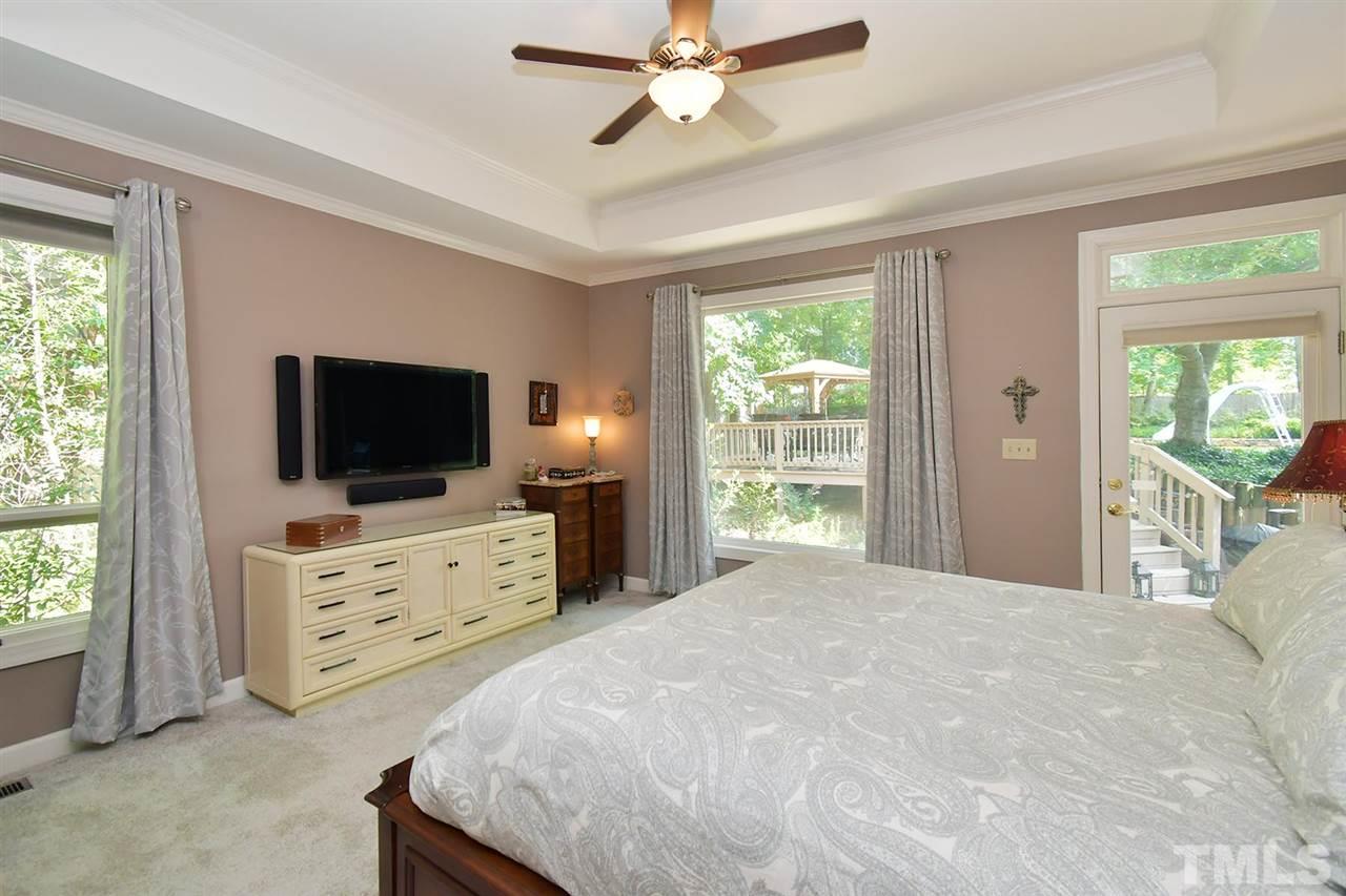 5220 Lenoraway Drive Raleigh, NC 27613 - Photo 13 of 30 First floor Master Bedroom with back door access to deck and stone patio.