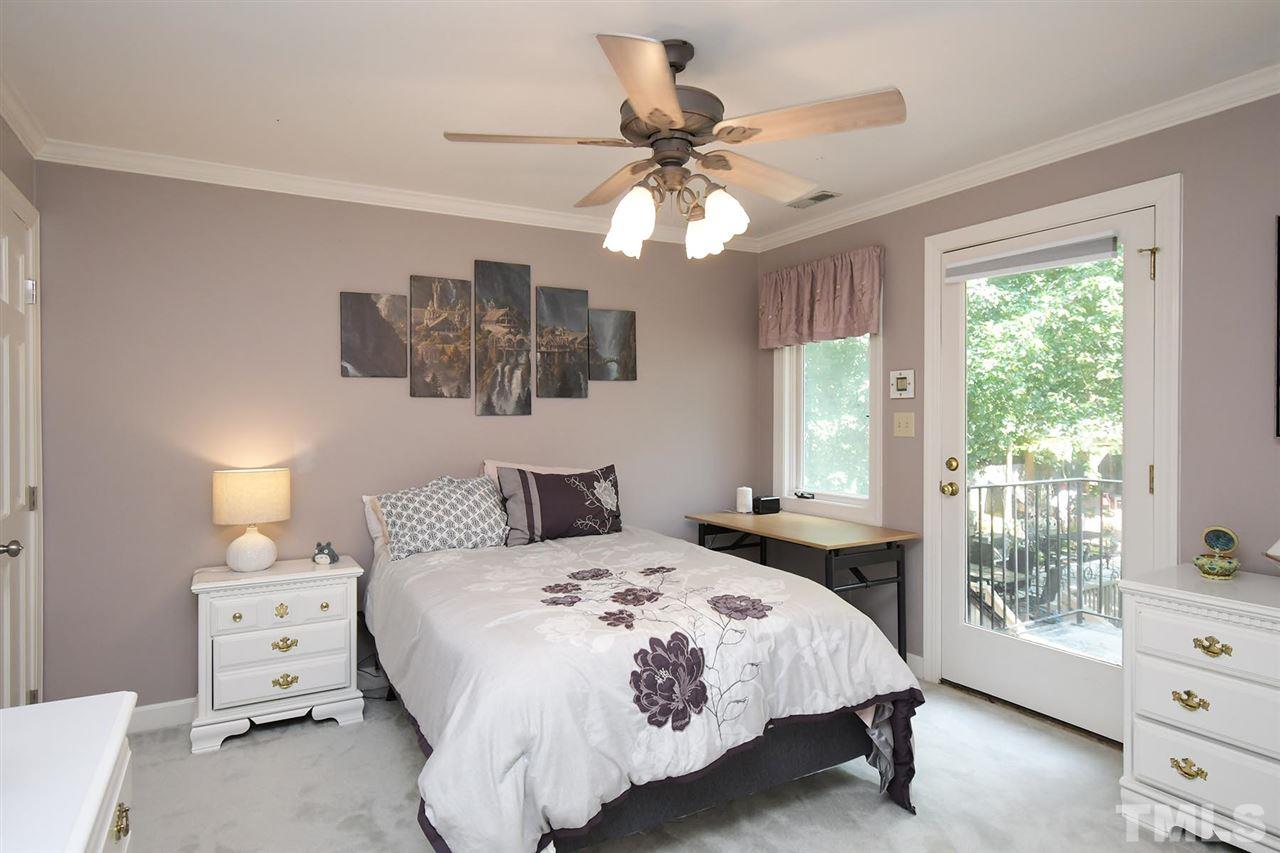 5220 Lenoraway Drive Raleigh, NC 27613 - Photo 18 of 30 Bedroom 2 on second floor with door to balcony overlooking gorgeous view of pool/backyard.