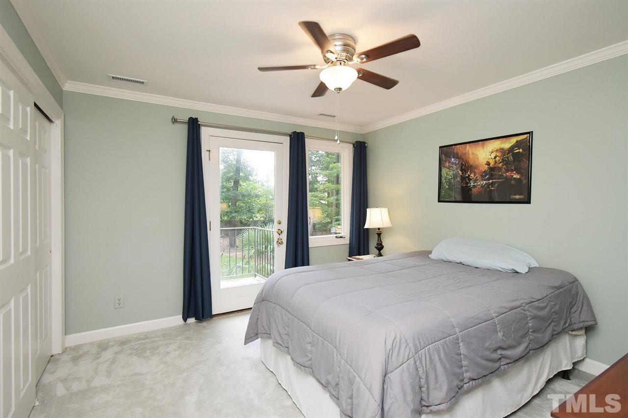 5220 Lenoraway Drive Raleigh, NC 27613 - Photo 20 of 30 Bedroom 3 on second floor with door to balcony overlooking pool/backyard.