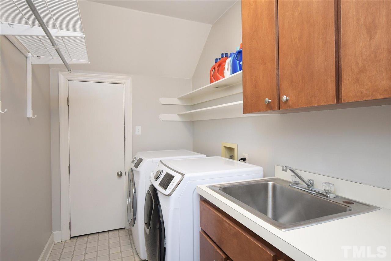 5220 Lenoraway Drive Raleigh, NC 27613 - Photo 23 of 30 Walk in Laundry Room with utility sink and cabinet storage above and below.
