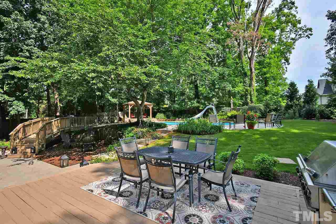5220 Lenoraway Drive Raleigh, NC 27613 - Photo 26 of 30 Large deck and stone patio in backyard. Beautiful space for entertaining.