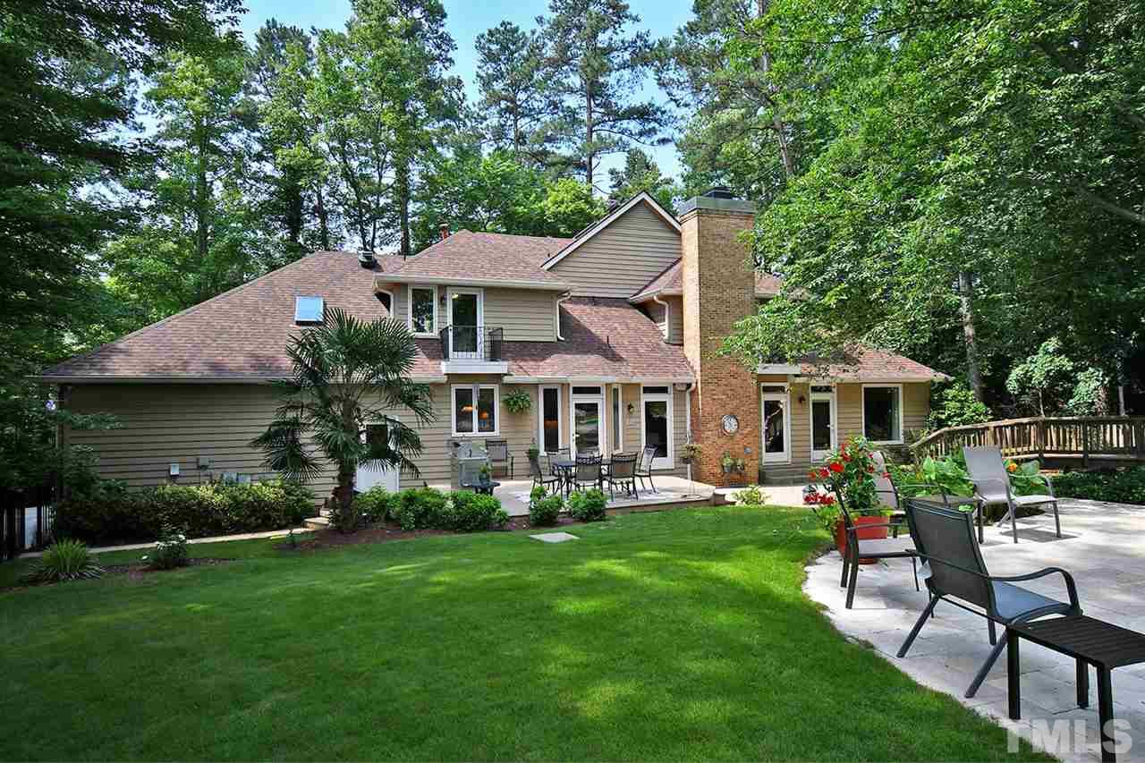 5220 Lenoraway Drive Raleigh, NC 27613 - Photo 29 of 30 Private wooded fenced backyard. View of deck, stone patio, and bridge that leads to Gazebo. Lots of room for playing, entertaining, or a fire pit!