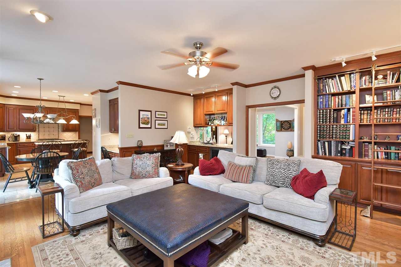 5220 Lenoraway Drive Raleigh, NC 27613 - Photo 6 of 30 Family Room has built in bookshelves, access to custom bar, and gas log fireplace.
