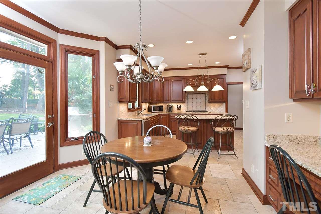 5220 Lenoraway Drive Raleigh, NC 27613 - Photo 9 of 30 Breakfast Nook has a built in desk with granite counter top and cabinets for storage space. Back door leads you to backyard oasis.