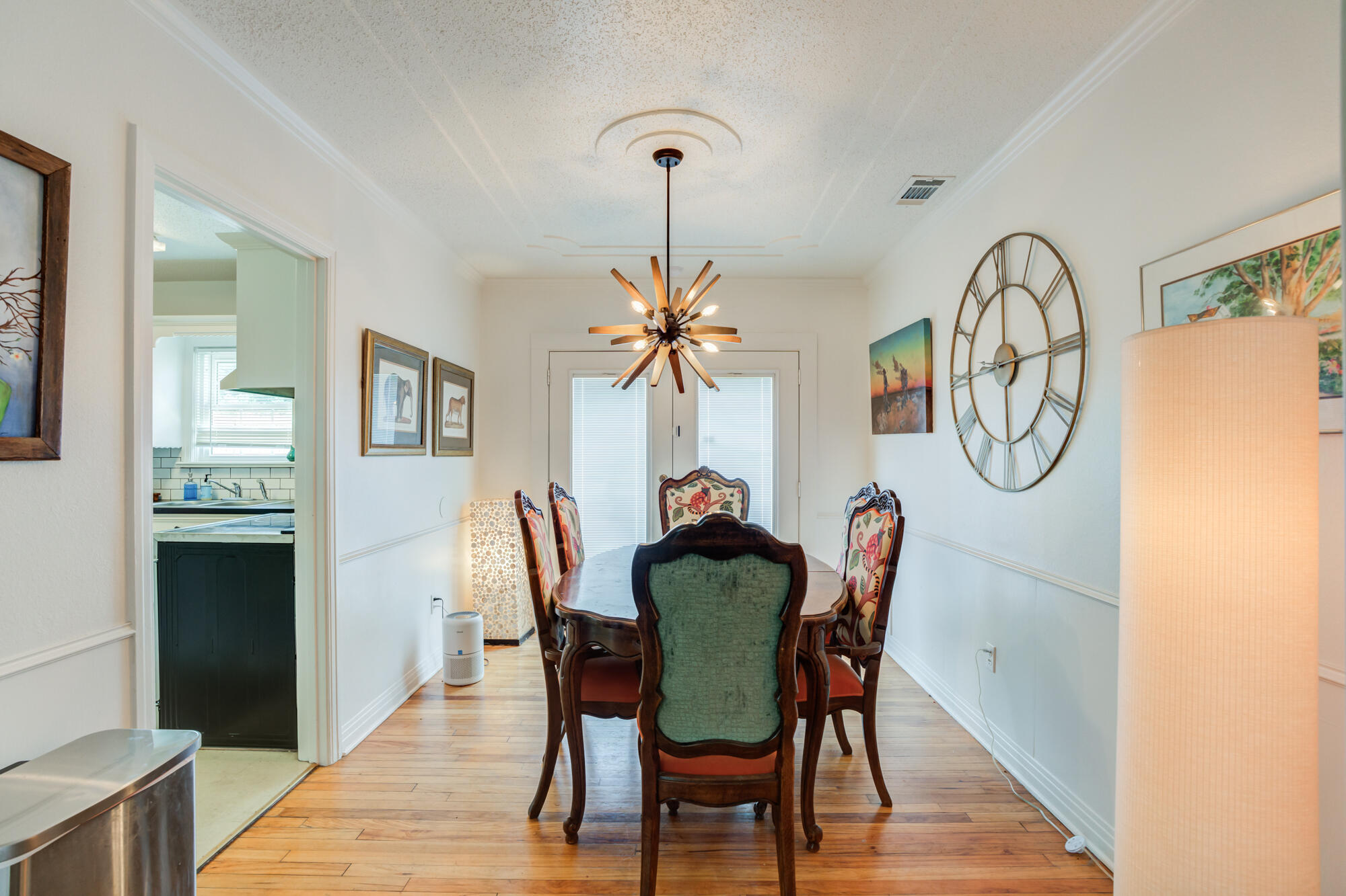 2826 33rd Street Lubbock, TX 79410 - Photo 17 of 33 a dining room with furniture a chandelier and wooden floor