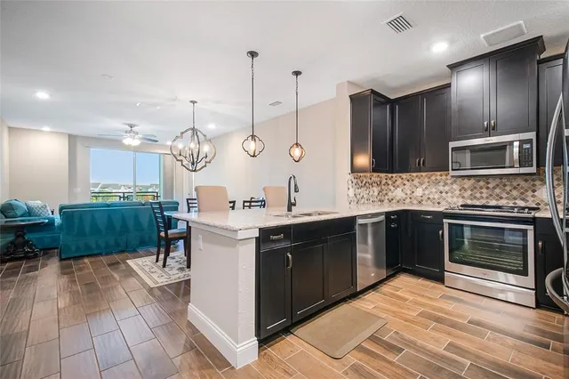 a kitchen with a sink cabinets and stainless steel appliances