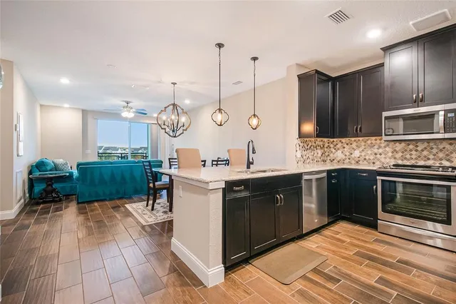 a kitchen with kitchen island white cabinets and a chandelier