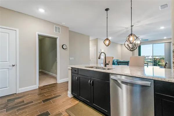 a kitchen with kitchen island a sink stove and refrigerator