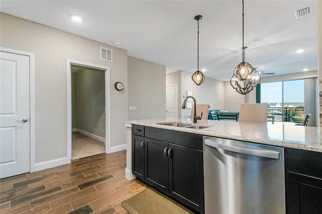 a kitchen with kitchen island a sink stove and refrigerator