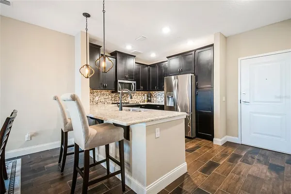 a dining room filled chandelier and wooden floor