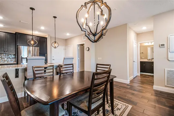 a view of a dining room with furniture wooden floor and chandelier
