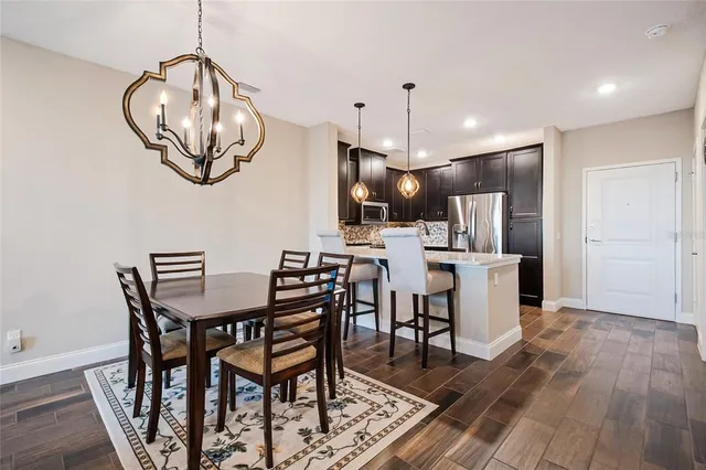 a view of a dining room with furniture wooden floor and chandelier
