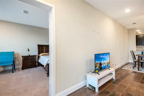 a spacious bedroom with a bed and a chandelier
