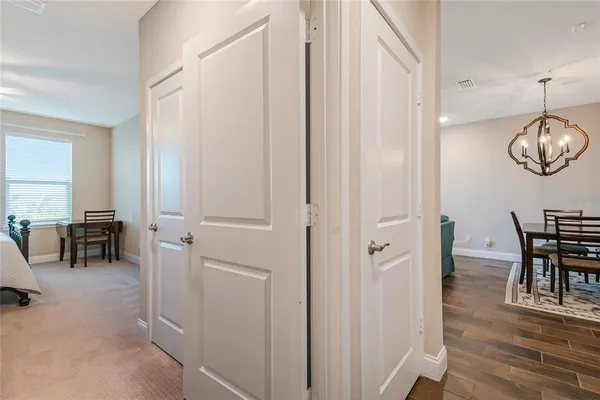a bedroom with a bed a table and chair