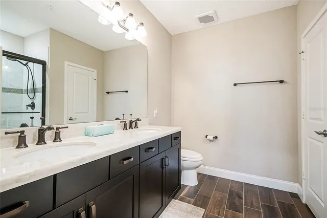 a bathroom with a double vanity sink and mirror