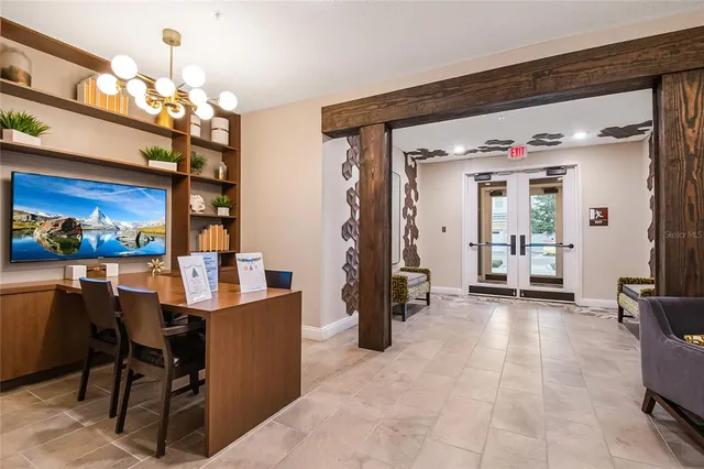 a view of a dining room with furniture and a chandelier