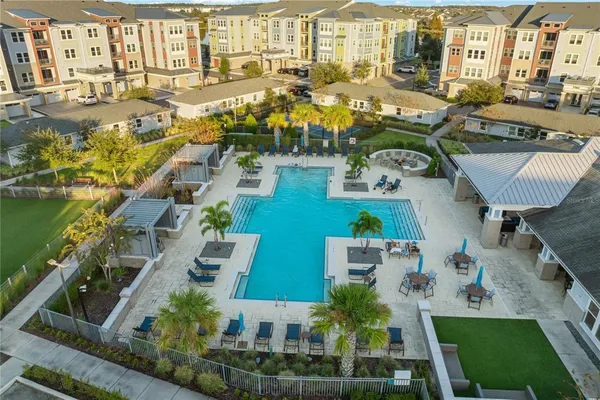 an aerial view of a backyard with table and chairs