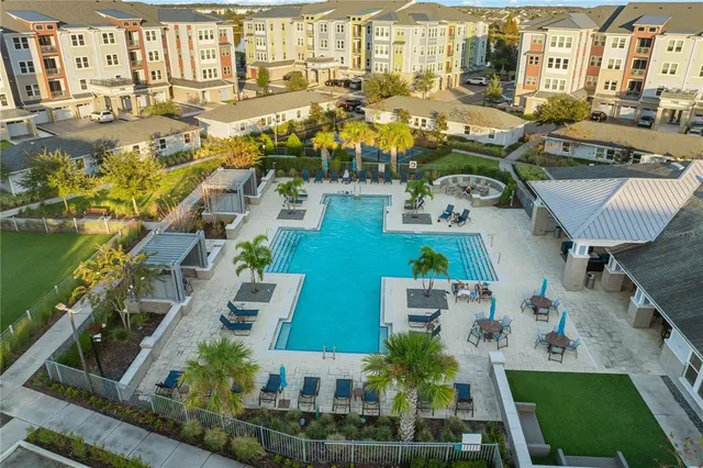 an aerial view of a backyard with table and chairs