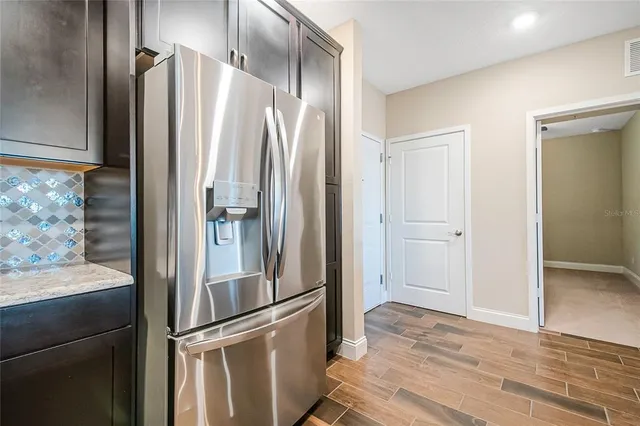 a kitchen with stainless steel appliances granite countertop a sink refrigerator and stove