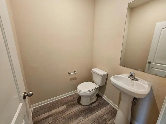 a bathroom with a sink toilet and a mirror