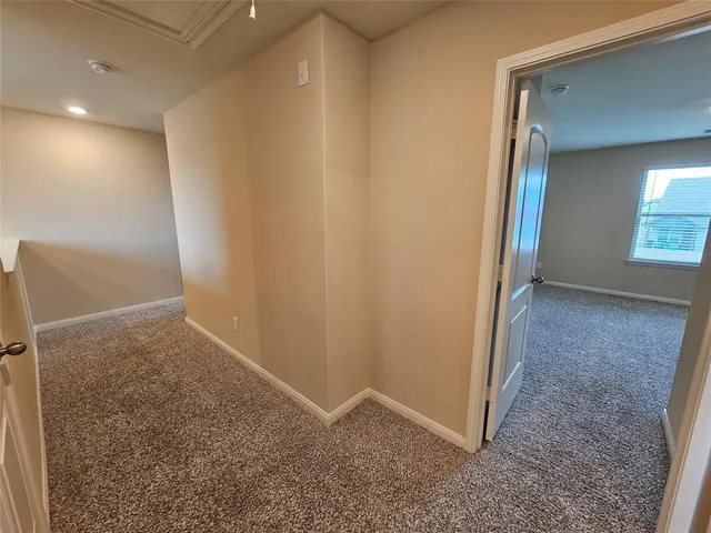 a view of hallway with stairs and wooden floor