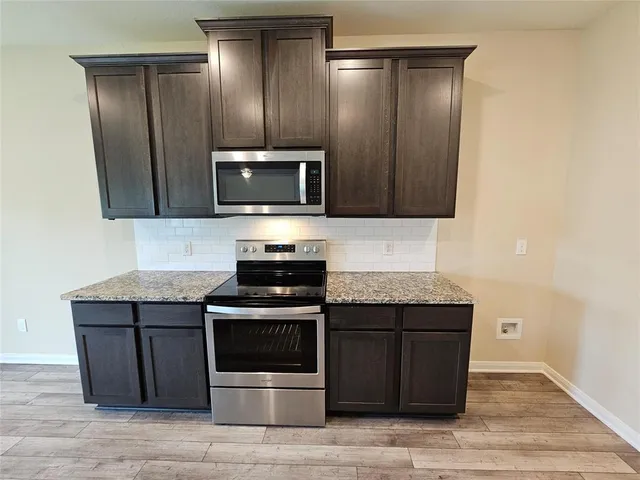 a kitchen with a stove and a microwave