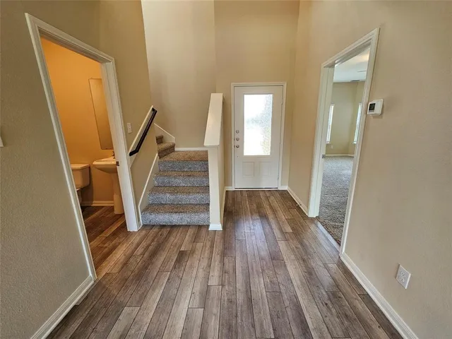 a view of staircase with white walls and railing