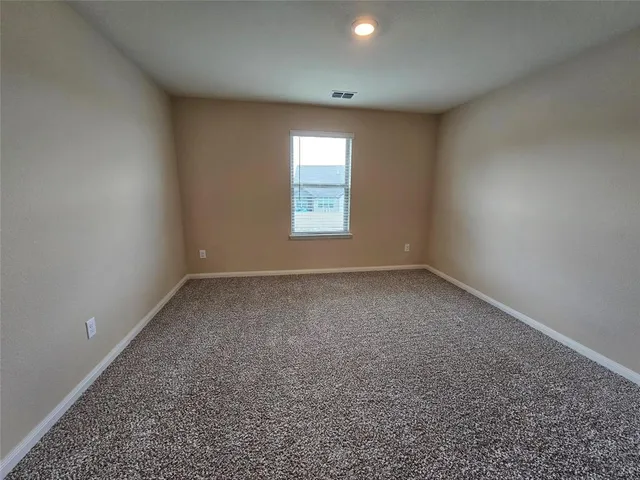a view of an empty room and closet area