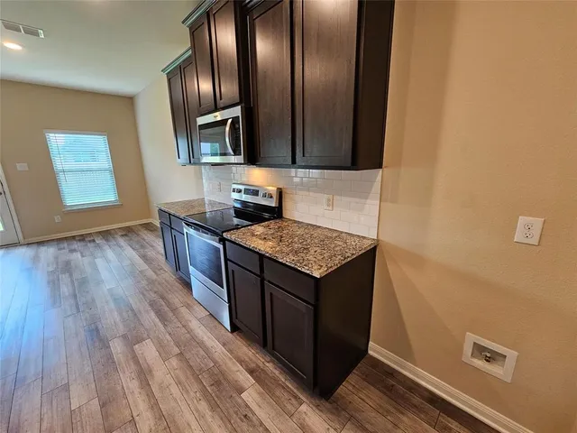 a view of a kitchen counter space and wooden floor