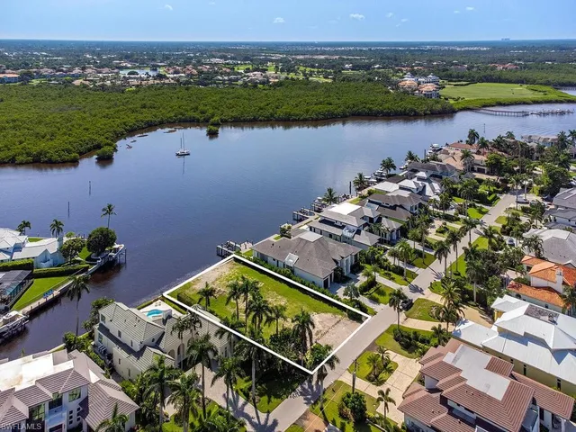 an aerial view of a house with a lake view