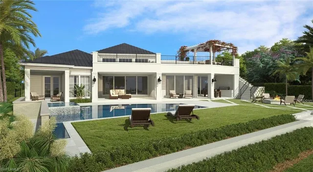 a front view of a house with swimming pool and chairs