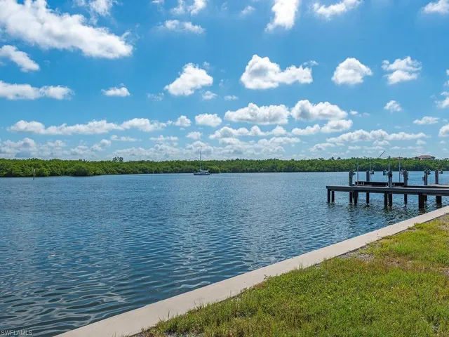 a view of a lake with couches in the patio