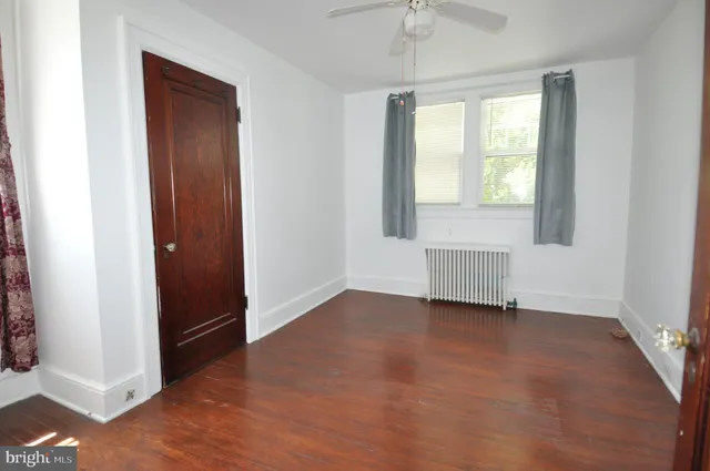 an empty room with windows and closet