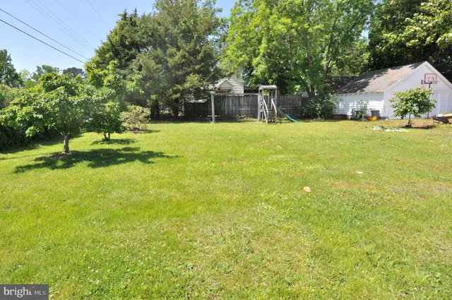 a house view with swimming pool in front of it
