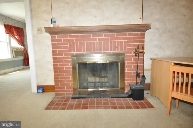 a living room with a fireplace and a rug