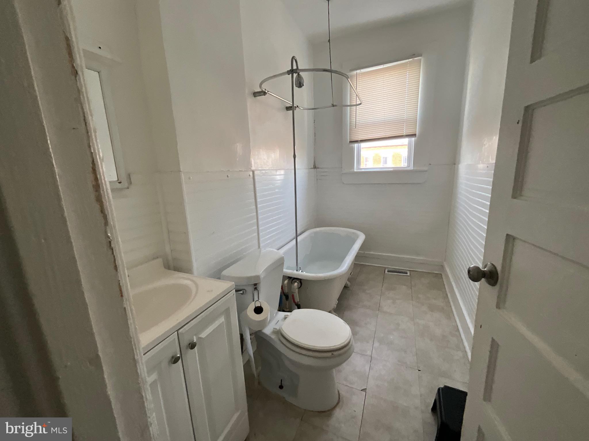 1723 East 25th Street Baltimore, MD 21213 - Photo 11 of 16 a bathroom with a toilet a sink and a shower
