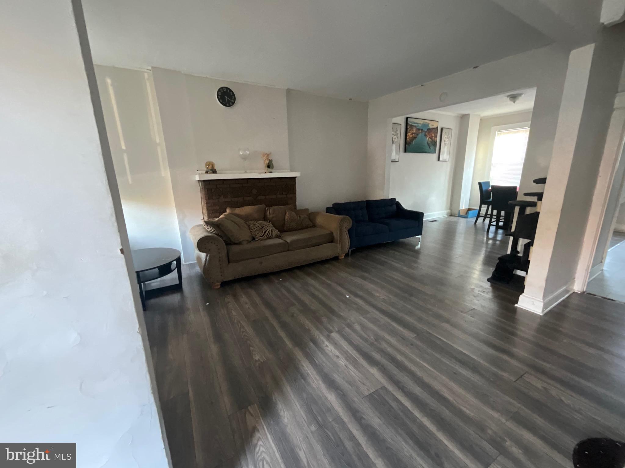 1723 East 25th Street Baltimore, MD 21213 - Photo 3 of 16 a living room with furniture and a wooden floor