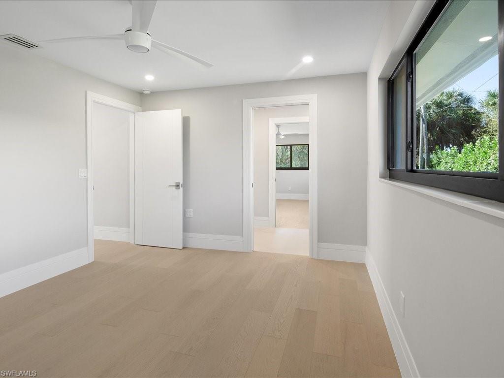 518 Cypress Way East Naples, FL 34110 - Photo 22 of 50 Unfurnished bedroom featuring recessed lighting, baseboards, visible vents, and light wood-type flooring