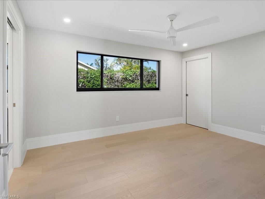 518 Cypress Way East Naples, FL 34110 - Photo 30 of 50 Unfurnished room with light wood-style flooring, recessed lighting, baseboards, and ceiling fan