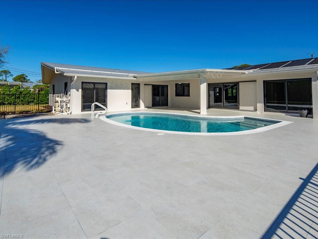 518 Cypress Way East Naples, FL 34110 - Photo 41 of 50 View of pool featuring a patio area, a fenced in pool, and fence