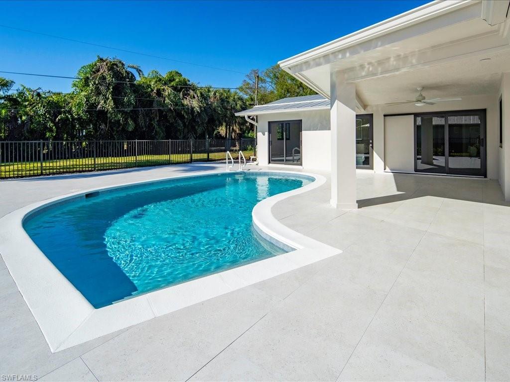 518 Cypress Way East Naples, FL 34110 - Photo 7 of 50 View of swimming pool with a fenced in pool, a patio, ceiling fan, and fence