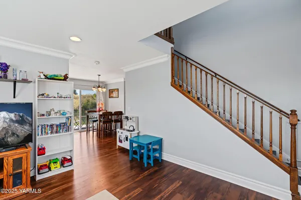a hallway with wooden floor and book shelf