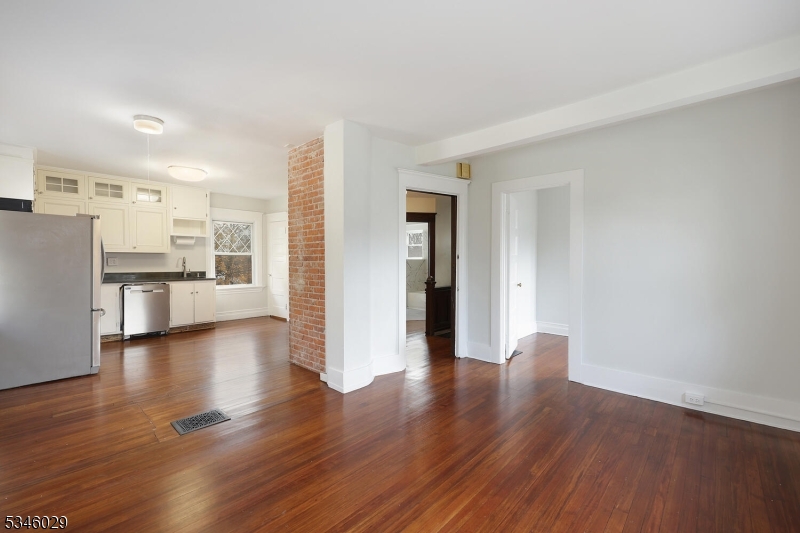 7 Olyphant Drive, Unit 2 Morristown, NJ 07960 - Photo 1 of 22 a view of a kitchen with a fridge and wooden floor