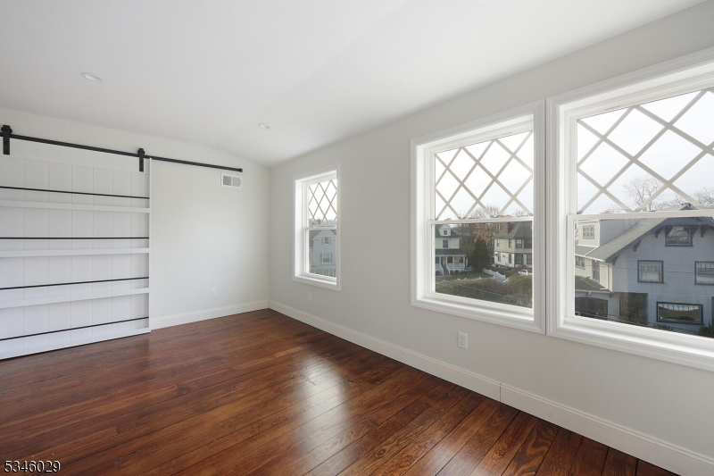 7 Olyphant Drive, Unit 2 Morristown, NJ 07960 - Photo 15 of 22 an empty room with wooden floor and windows