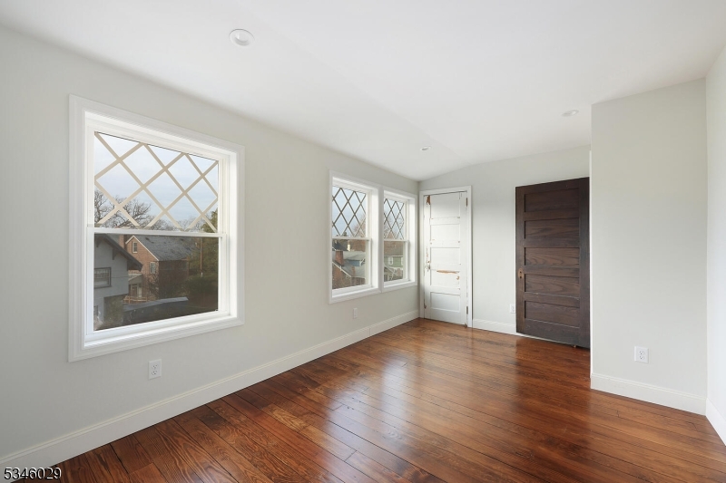 7 Olyphant Drive, Unit 2 Morristown, NJ 07960 - Photo 16 of 22 a view of an empty room with wooden floor and a window