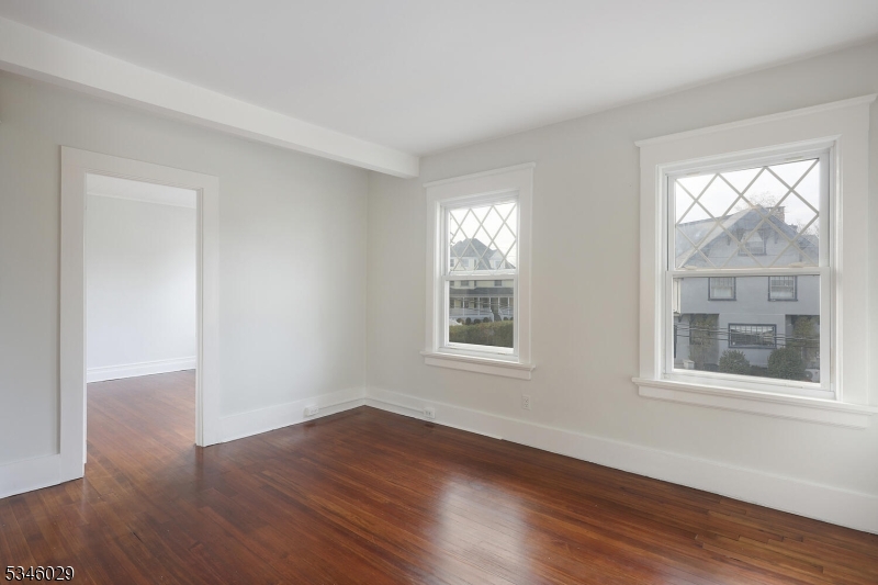 7 Olyphant Drive, Unit 2 Morristown, NJ 07960 - Photo 9 of 22 a view of an empty room with wooden floor and a window