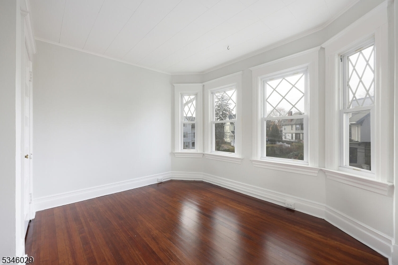 7 Olyphant Drive, Unit 2 Morristown, NJ 07960 - Photo 10 of 22 a view of an empty room with wooden floor and a window
