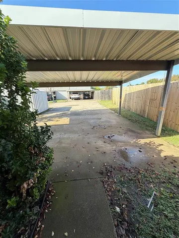 a kitchen with stainless steel appliances kitchen island granite countertop wooden cabinets a sink a stove and a refrigerator