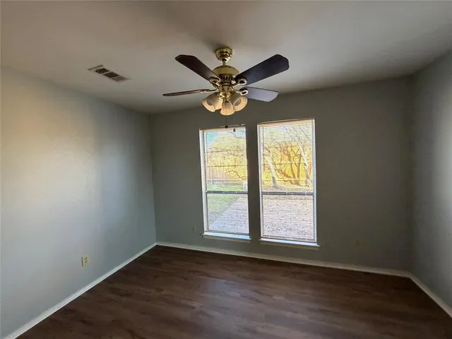 a view of a room with wooden floor and a fireplace