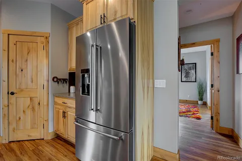 a metallic refrigerator freezer sitting in a kitchen